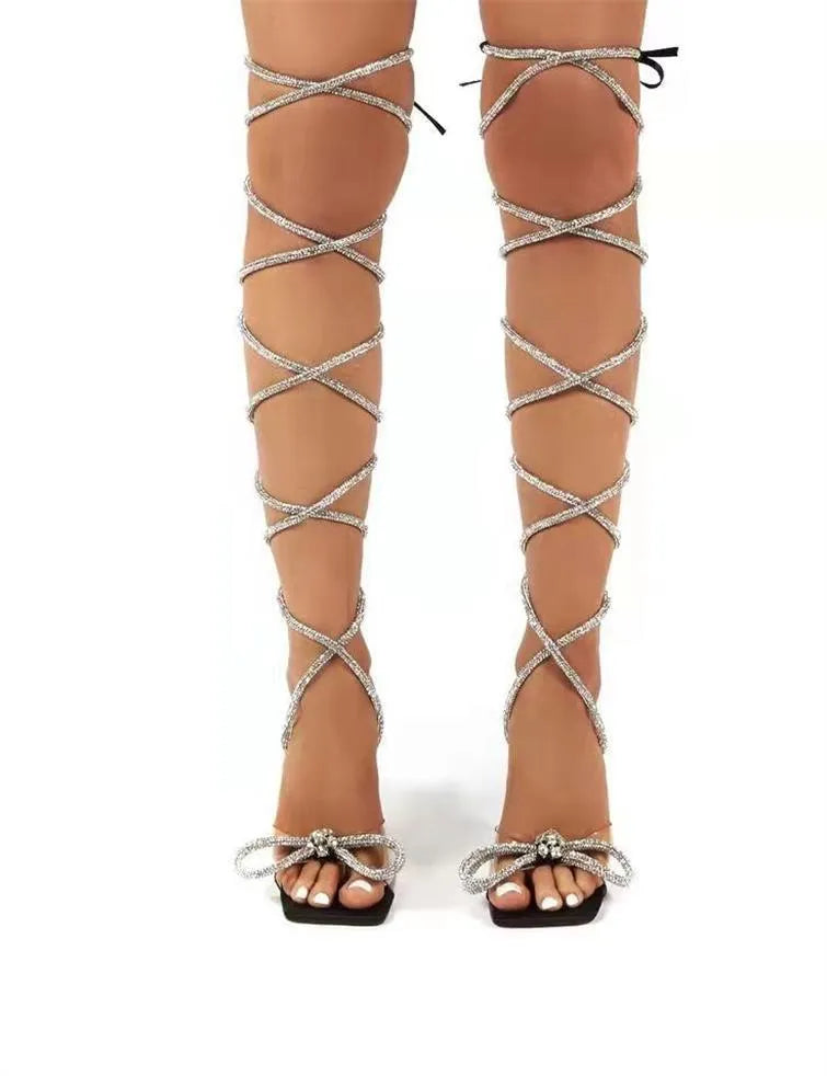Plus size women's shoes with Roman rhinestone straps in PU with a rubber sole and square toe, available in black, beige, and colourful plus-size sandal options in sizes 35 to 43.