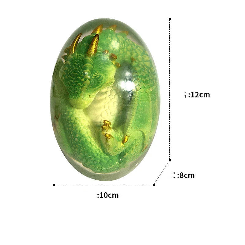 A lifelike resin dragon egg ornament with a crystal-clear, transparent design, sitting on a glowing lava-style base.