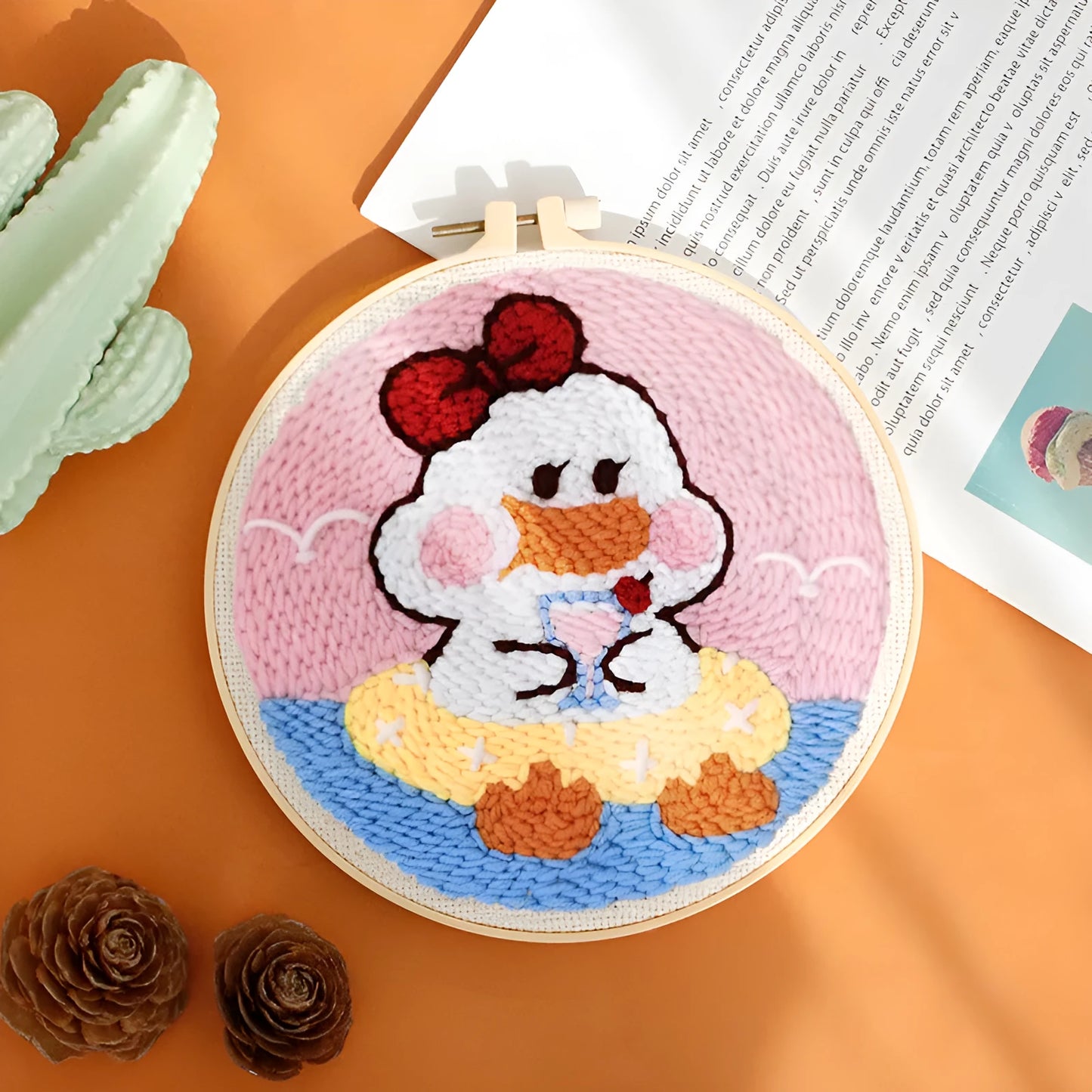 Handmade embroidery kit with cartoon animal designs on linen fabric including flamingo, whale and deer patterns