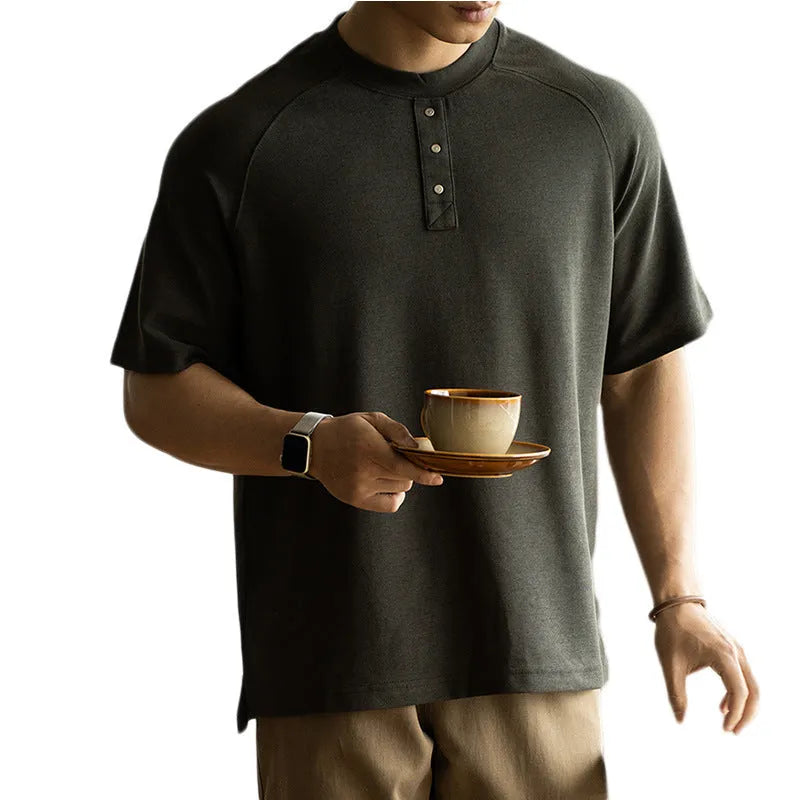 Women's loose grey terry texture casual pullover top with raglan sleeves on a hanger.