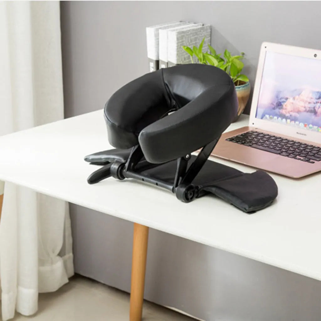 U-shaped black SPA facial massage pillow with adjustable height, shown with its zippered nylon carry case