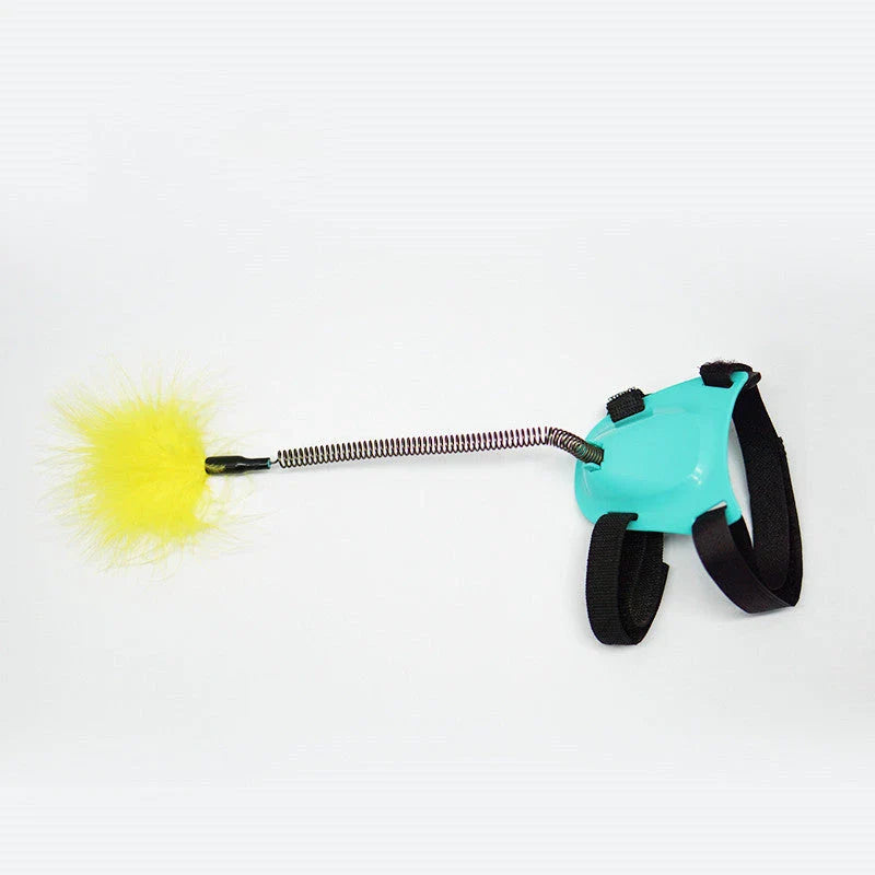 Playful cat chasing and pouncing on a feather-tipped wand toy designed to engage their natural hunting instincts