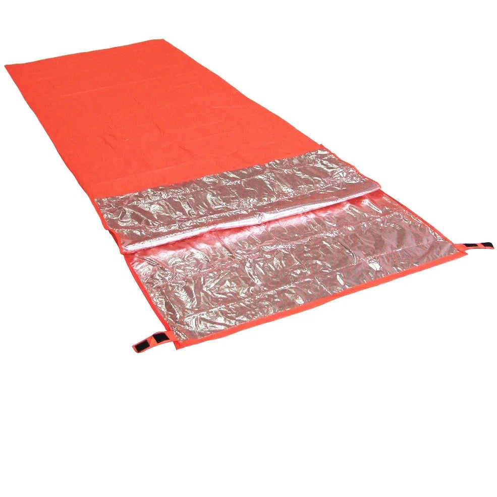 Orange outdoor thermal sleeping bag with silver coated nylon showing envelope design and storage bag