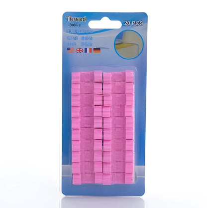 Self-adhesive plastic cable organiser clips in various colours holding a bundle of wires against a wall.