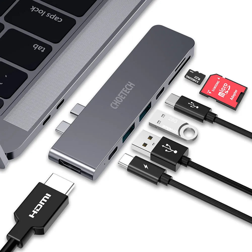 Silver aluminium USB-C hub adapter with SD card slot, Micro SD slot, HDMI, USB ports, and USB-C connector.