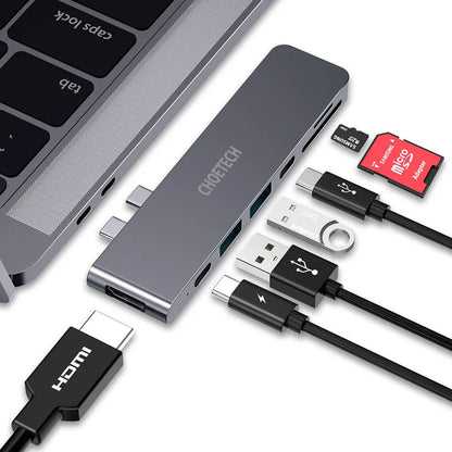 Silver aluminium USB-C hub adapter with SD card slot, Micro SD slot, HDMI, USB ports, and USB-C connector.