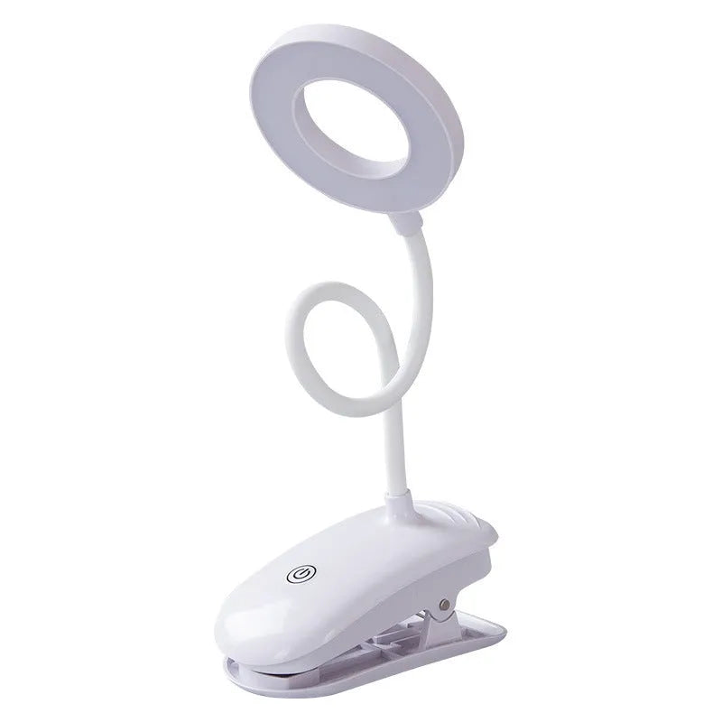 A modern white clip-on rechargeable desk lamp with a touch-sensitive switch and a plastic shade.