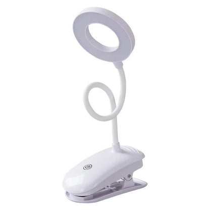 A modern white clip-on rechargeable desk lamp with a touch-sensitive switch and a plastic shade.