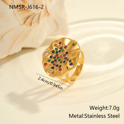 Geometric open-mouth stainless steel ring with pleated inlaid colour diamonds on a white background.