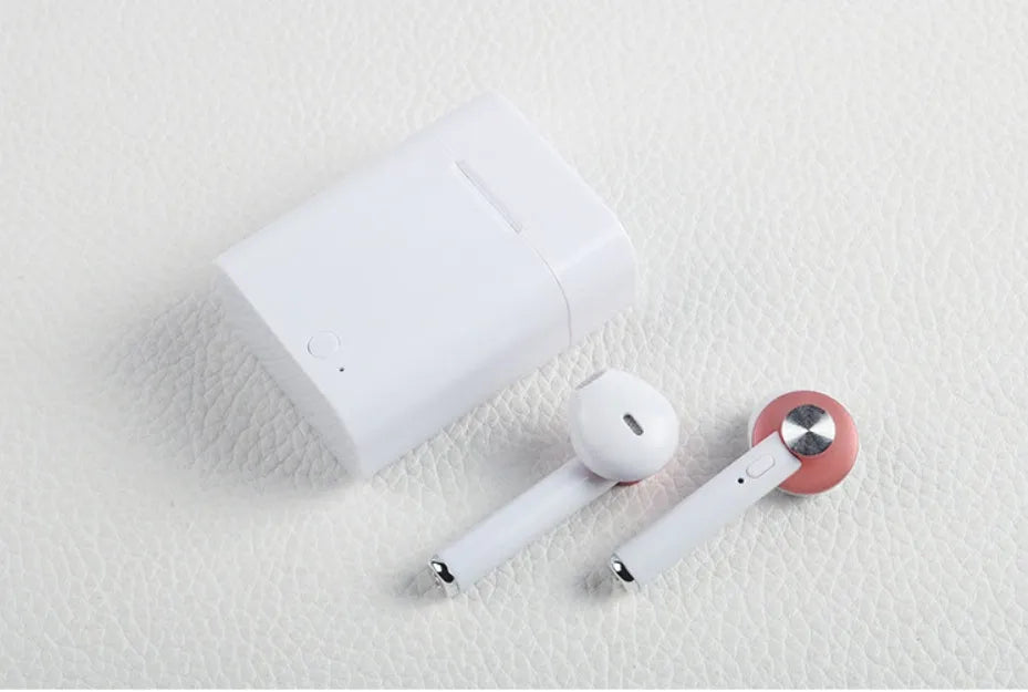 Black wireless sports Bluetooth earbuds showing battery display and placed next to a smartphone.