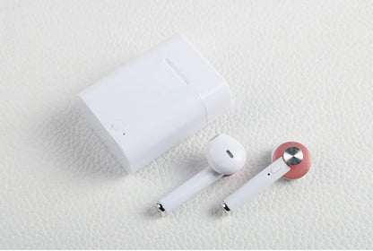 Black wireless sports Bluetooth earbuds showing battery display and placed next to a smartphone.