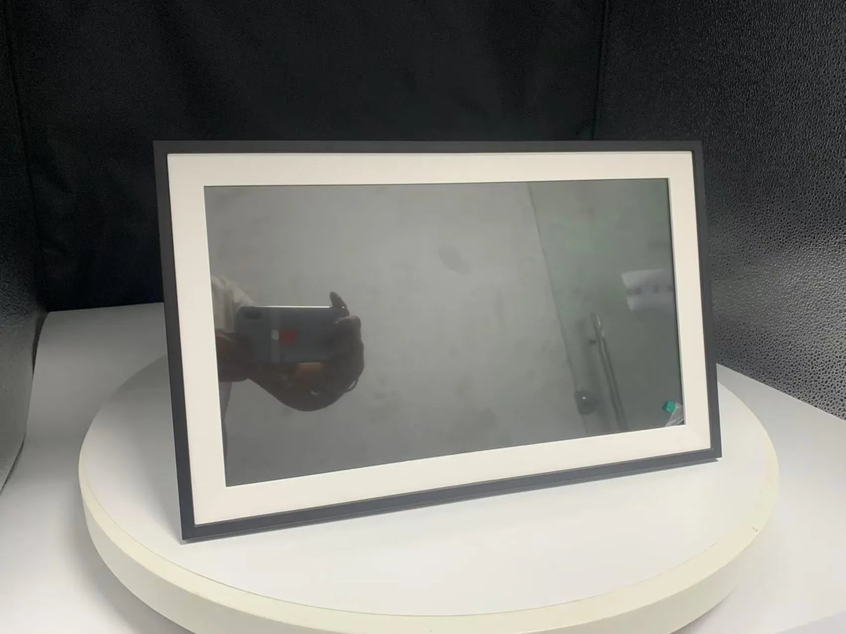 White Smart Digital Photo Frame with 15.6 inch screen displaying a family photo, shown on a wooden shelf.