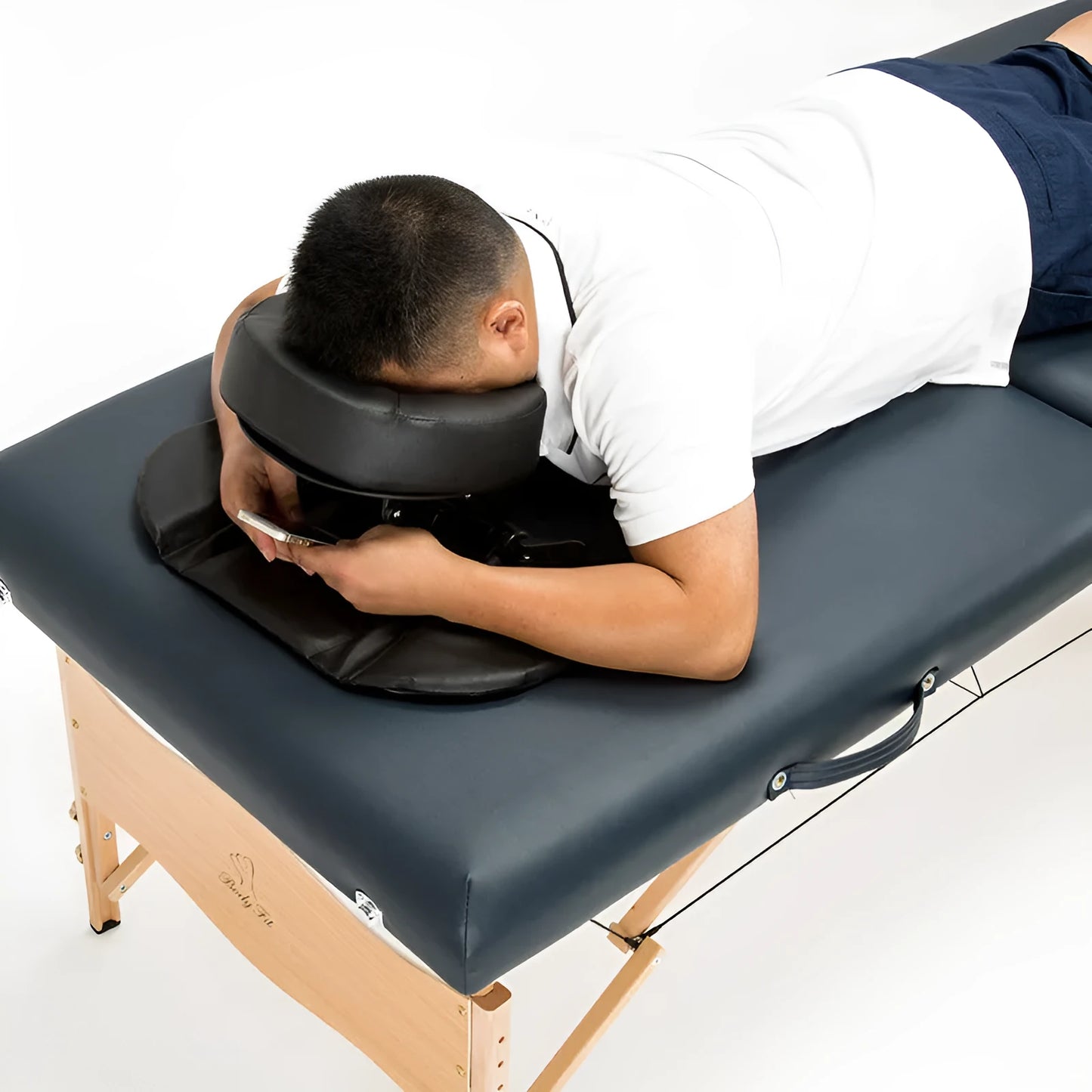 U-shaped black SPA facial massage pillow with adjustable height, shown with its zippered nylon carry case