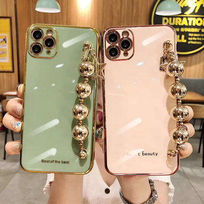 Electroplated bead wrist strap bracelet case for iPhone in light green, pink, and dark green, TPU back cover.