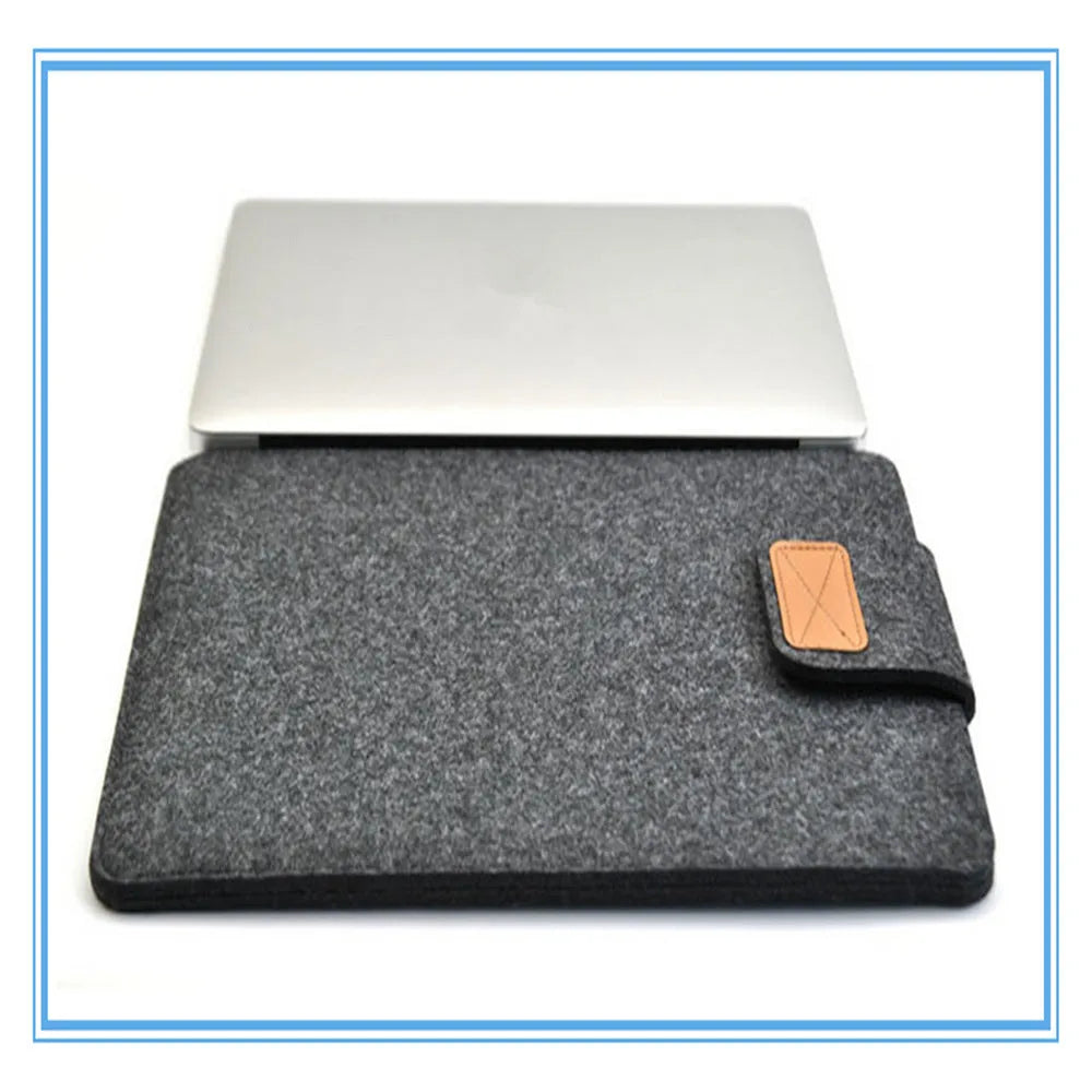 Dark grey clamshell laptop bag open to show plush internal liner and corner protectors.
