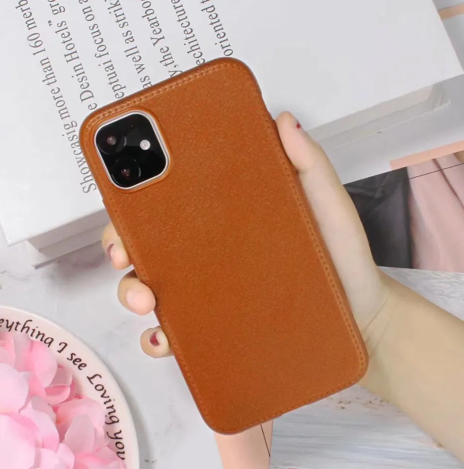 Leather-textured TPU phone case for iPhone in black, brown, navy blue, or wine red colour options.