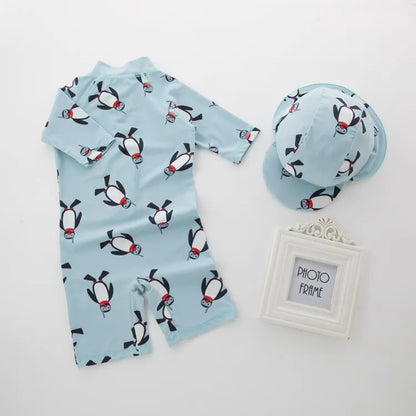Boy's penguin-print long sleeve swimsuit with matching swimming cap for sun protection