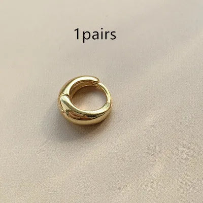 Women's minimalist geometric water drop earrings in gold and silver, shown in large, medium, and small sizes.