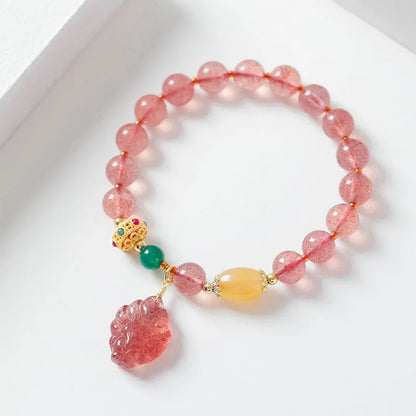 Women's strawberry quartz crystal beaded bracelet with Nine Tail Fox design on wrist