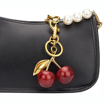 Red zinc alloy cherry-shaped keychain pendant on a key ring.