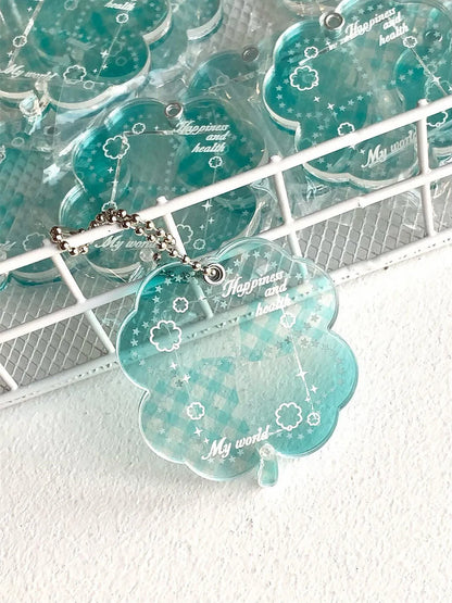 Four-leaf clover shaped acrylic phone pendant keychain in blue, green, and mint colour options