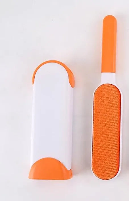 Blue reusable pet hair removal brush with double-sided head next to its self-cleaning base.