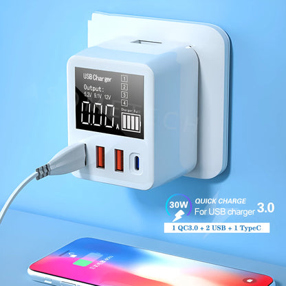 White 4-port USB travel wall charger with LED display and UK plug for fast charging phones and tablets.