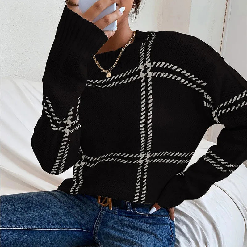 Women's loose-fitting plaid crew neck sweater with apricot, black, beige, red, and green colour-block stripes.