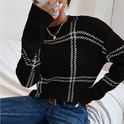 Women's loose-fitting plaid crew neck sweater with apricot, black, beige, red, and green colour-block stripes.