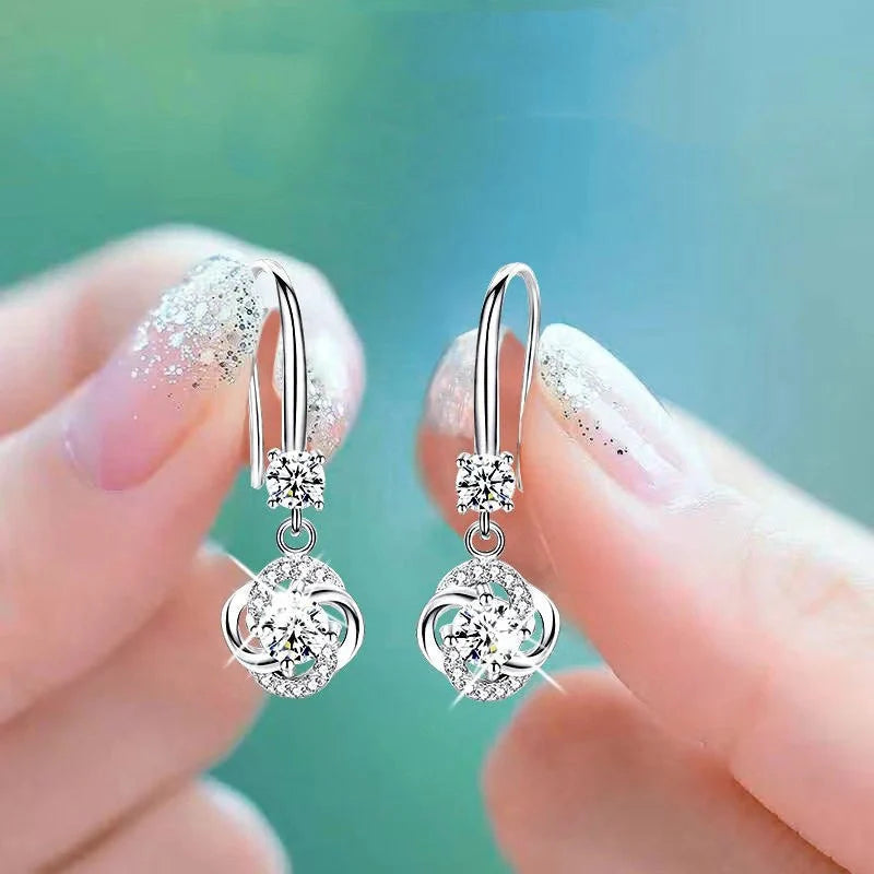 Silver stud earrings with four-leaf clover design and fairy ear hooks