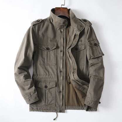 Men's loose-fit cotton zip jacket in light brown colour on a hanger, showing stand collar and front zip.