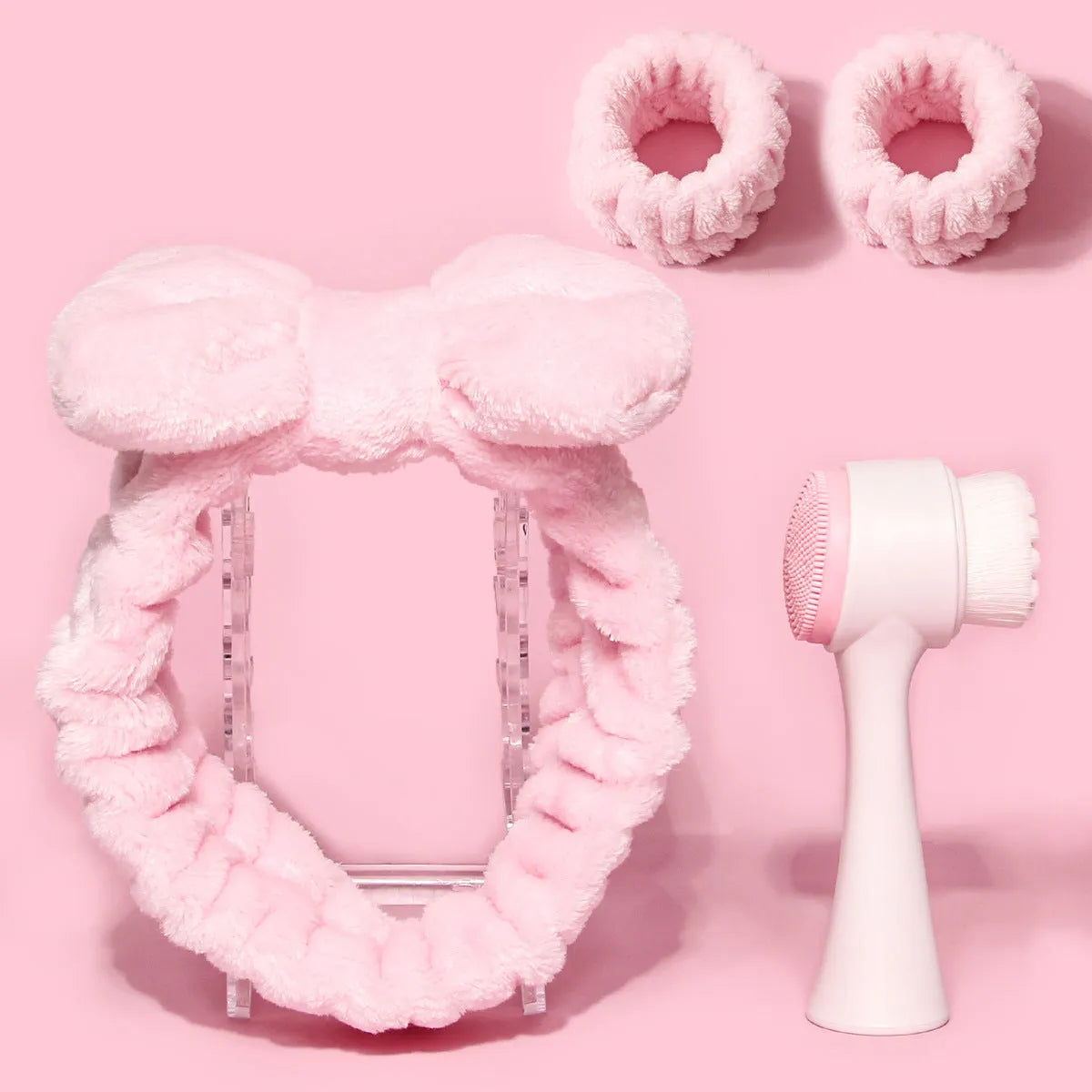 Facial brush set with coral fleece hair band and four nylon-bristle brushes in purple, grey, white, or pink colours