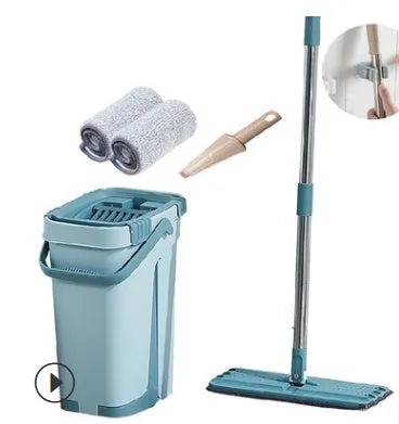 Blue flat floor mop with rotating head and microfiber pad beside plastic bucket for floor cleaning