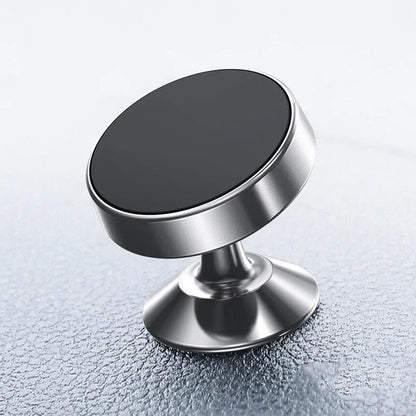 Silver aluminium alloy magnetic car phone holder with rotating ball head mounted on a car air vent.