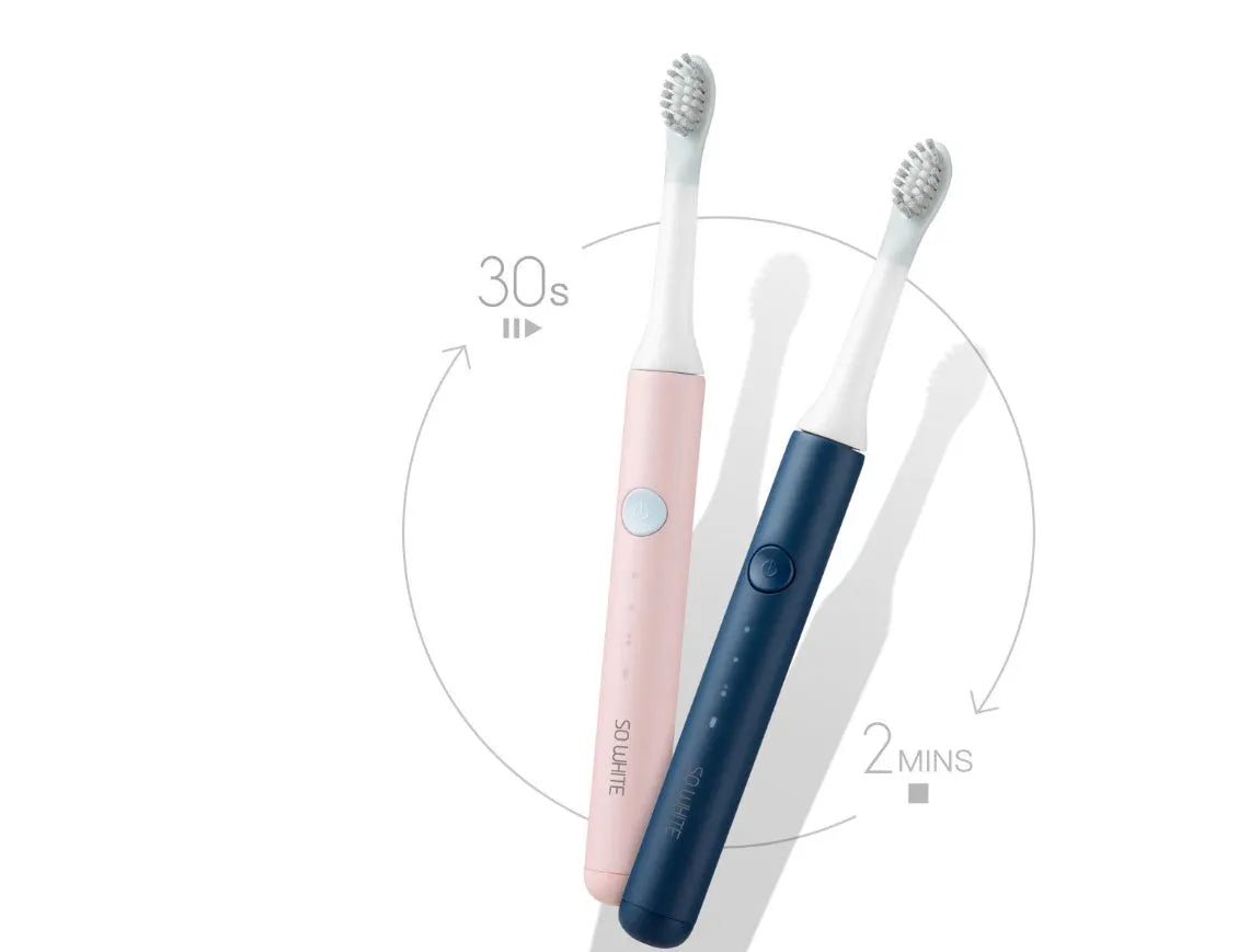SOOCAS sonic electric toothbrush in blue or pink with round brush head on a bathroom counter.