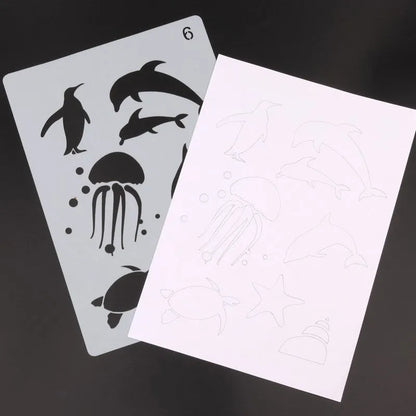 White plastic drawing stencil set with geometric cut-out patterns including hearts and stars