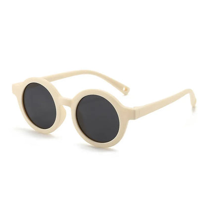 Children's round-frame polarised sunglasses with soft TPEE frame for ages 0-3, shown in assorted colours.