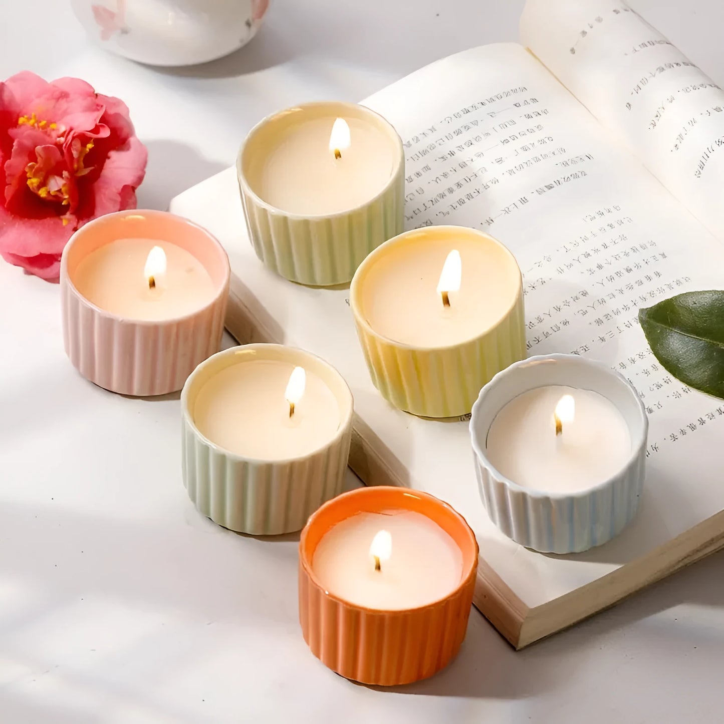 Soy wax aromatherapy candle inside a handmade ceramic cup, shown in a mint green colour.