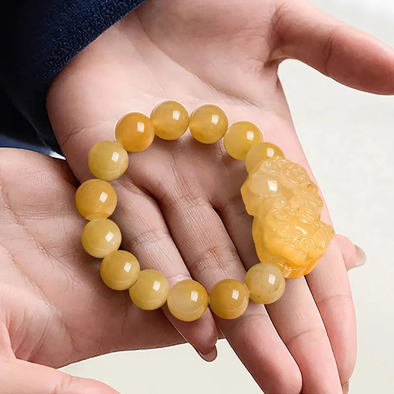 Carved jinsi jade money bracelet in golden thread colour with jade bead detailing
