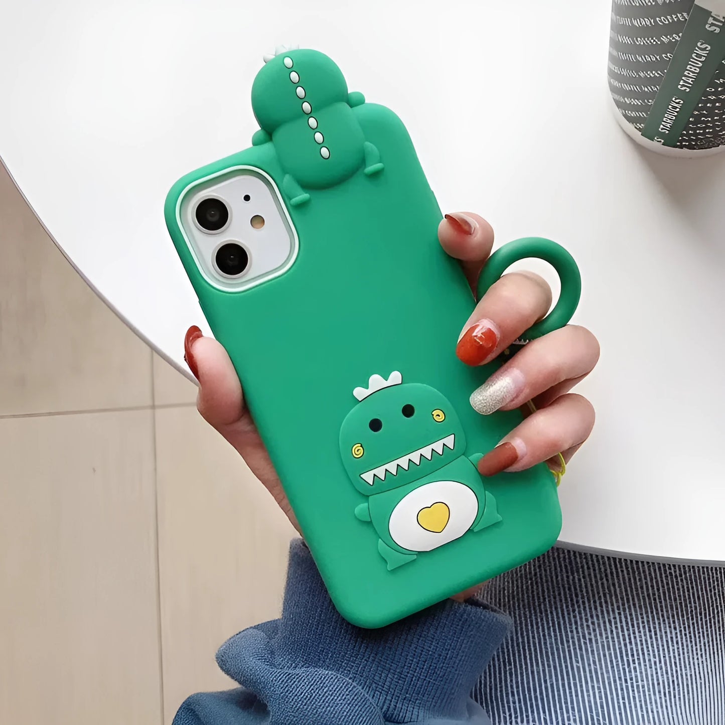Green silicone iPhone case with animal cartoon design showing drop protection and waterproof features