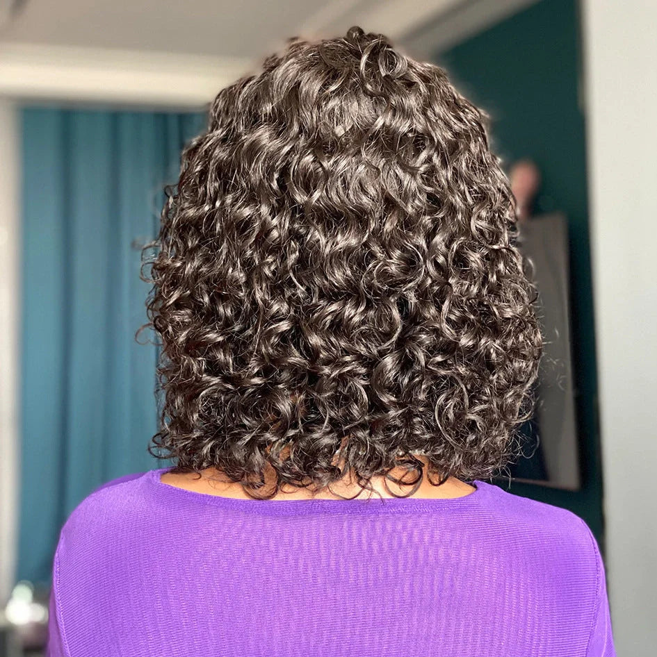 Deep curly fringe human hair wig with bangs, 12-inch length, showing adjustable headgear and even bangs design