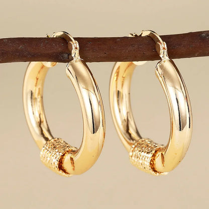 Geometric copper ear clips for women with ring and line elements in golden colours