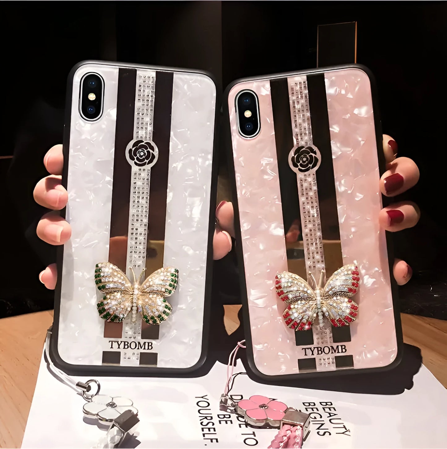 Decorative acrylic iPhone case featuring a diamond butterfly design with a mirror, shown in rose colour.