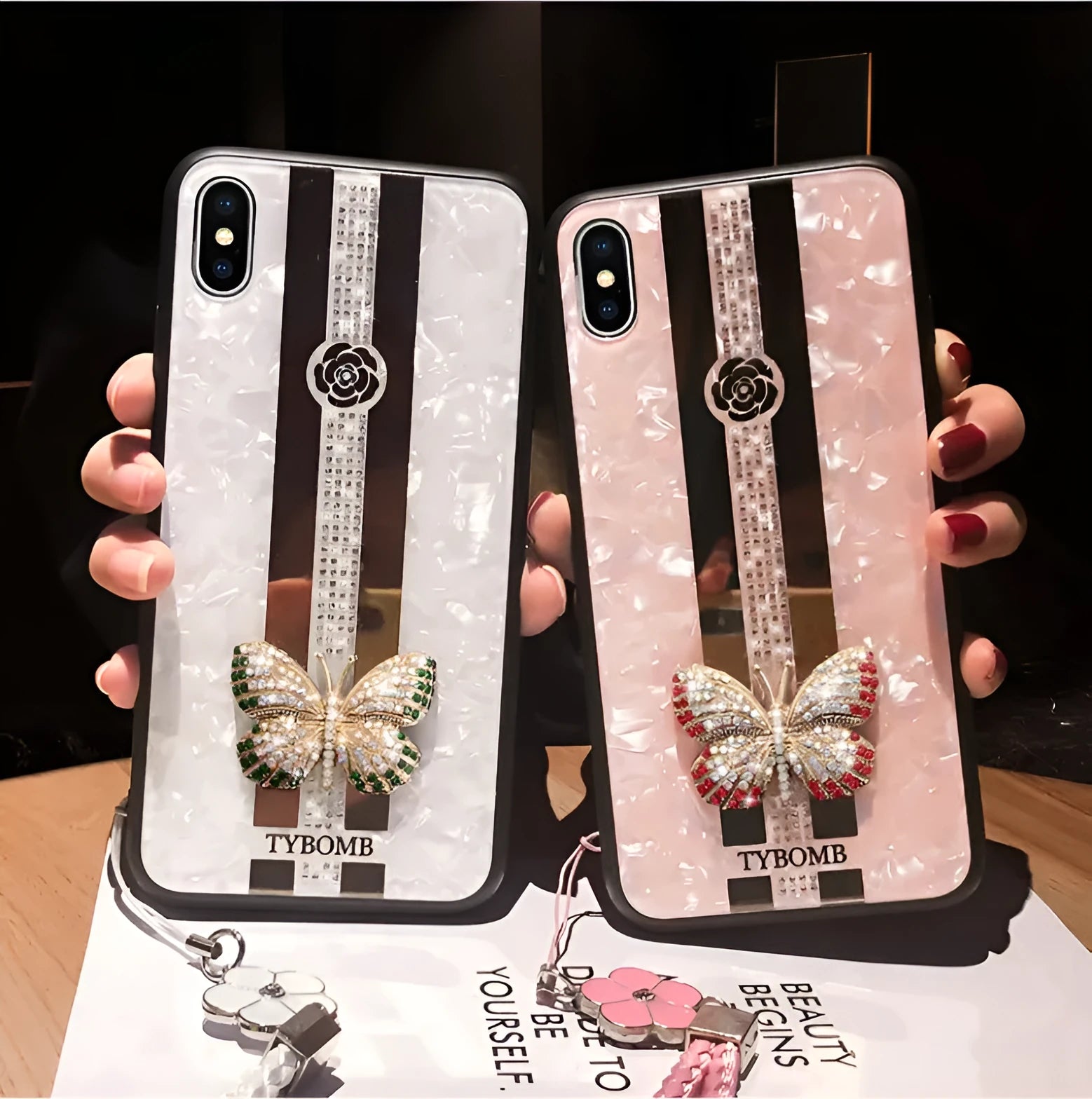 Decorative acrylic iPhone case featuring a diamond butterfly design with a mirror, shown in rose colour.