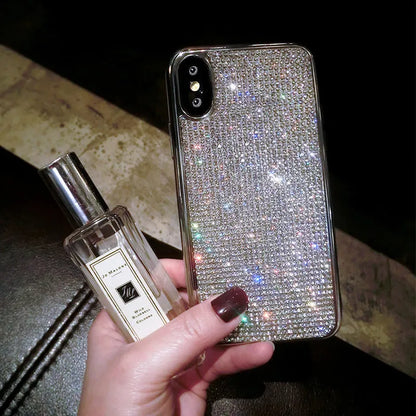 Silver full diamond silicone phone case for iPhone, showing camera and button cut-outs.