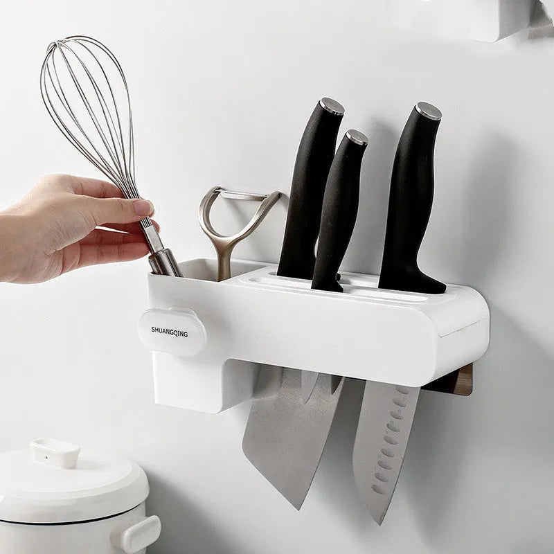 White modern plastic knife block holding six kitchen knives on a countertop.