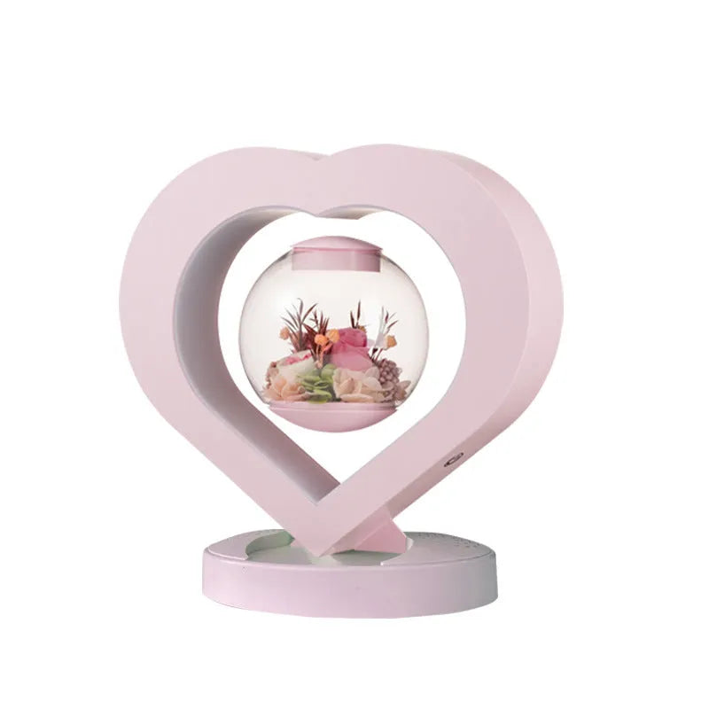 Pink preserved rose ornament with Bluetooth speaker and LED light on wooden table