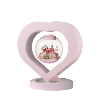 Pink preserved rose ornament with Bluetooth speaker and LED light on wooden table
