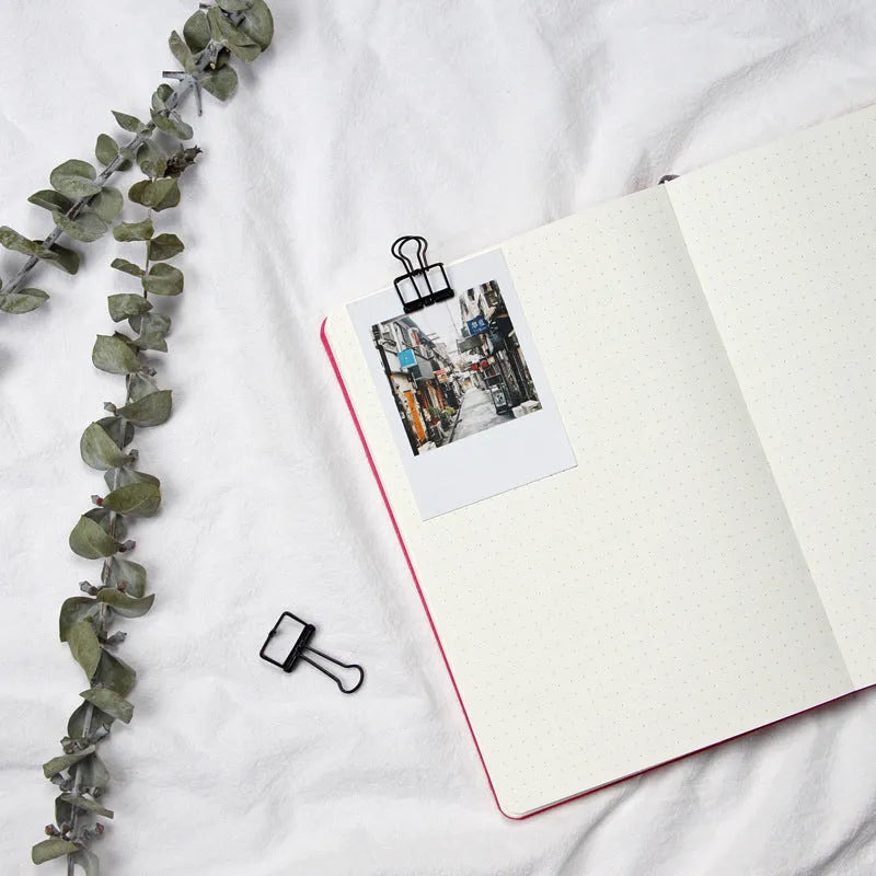 Blue soft imitation leather A5 dotted notebook open on dot grid pages.