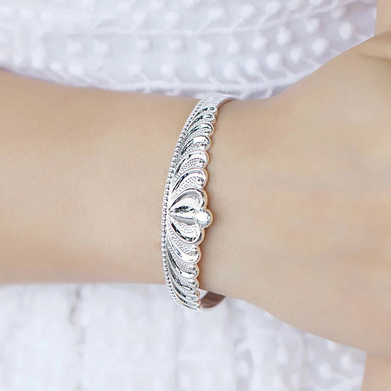 A close-up view of the elegant Crown Bracelet, showcasing its intricate crown-shaped design and shiny, rhodium-plated finish.